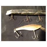 1 wooden with metal tail Musky fishing lures and 1 other fishing lure