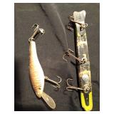 1 wooden with metal tail Musky fishing lures and 1 other fishing lure