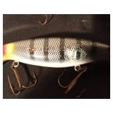 The Believer fishing lure and a wooden Musky fishing lure with metal tail