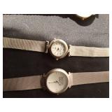 4 wrist watches and a pocket watch