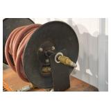 Hose Reel with Red Rubber Hose on a Metal Spool and Hand Crank