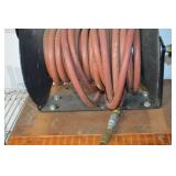 Hose Reel with Red Rubber Hose on a Metal Spool and Hand Crank