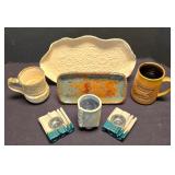 LR - Decorative Tableware Lot: Ivory Oval Tray; Blue/Rust Tray; Blue Vase; Brown & Tan Mugs; Candleholders