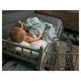 Baby doll in crib, toy shopping car...