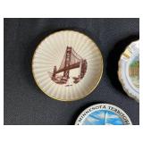 Collection of Vintage Souvenir Plates, Wicker Basket, Russian Nesting Doll, and Decorative Items