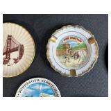 Collection of Vintage Souvenir Plates, Wicker Basket, Russian Nesting Doll, and Decorative Items