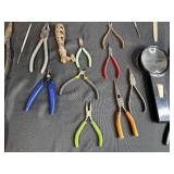 Collection of Hand Tools with Pliers, Files, Screwdrivers, and Magnifier