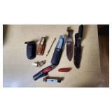 Lot of Knives and Tools Including Buck Knife, Victorinox Swiss Army Knife, and Vintage Fixed Blade