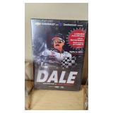 NASCAR Collectibles Including Ertl Die-Cast Car, Dale JR and Jeff Gordon Ornaments, and Dale Earnhardt Documentary