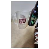 Collection of Beer Memorabilia including Schlitz Pitcher, Budweiser Mardi Gras 2001 Bottle, and Bad Habit Brewing Growler