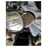 Spalding and Dunlop Golf Club Bags with Various Clubs