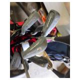 Spalding and Dunlop Golf Club Bags with Various Clubs