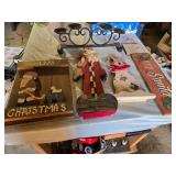 Christmas-themed decorations including Santa signs and candle holder, plus holiday decor items