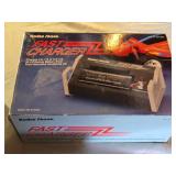 Radio Shack Fast Charger and a RGM-79SP GM Sniper II model kit, and a toy ATV with rider.