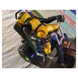 Radio Shack Fast Charger and a RGM-79SP GM Sniper II model kit, and a toy ATV with rider.