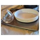 Slow cooker with digital display, baking dish, cutting boards, and floral arrangement