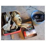Ratchet straps, bungee cords, and hardware items including a blue bucket