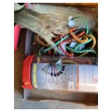 Ratchet straps, bungee cords, and hardware items including a blue bucket