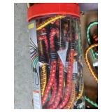 Ratchet straps, bungee cords, and hardware items including a blue bucket