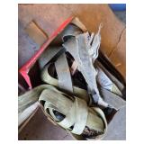 Ratchet straps, bungee cords, and hardware items including a blue bucket