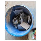 Ratchet straps, bungee cords, and hardware items including a blue bucket