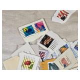 Lot of Postage Stamps Featuring Various Designs and Themes