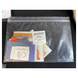 Collection of Handmade Cross-Stitch Ornaments and Craft Supplies