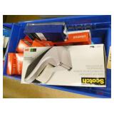 Office supplies, probably 25 tape dispensers, new boxes of tape, paper clips and a bunch of note pads