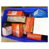 Office supplies, probably 25 tape dispensers, new boxes of tape, paper clips and a bunch of note pads