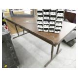 Folding table with custom 32 slot organizer and a paper roll dispenser