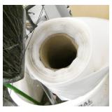 garbage barrel with roll of poly and broom