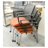 Set of 4 Orange cushion stacking chairs with wheels