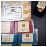 an assortment of 6 various gold plated coins: 3 IHP