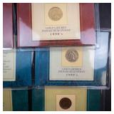 an assortment of 6 various gold plated coins: 3 IHP