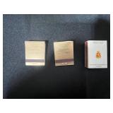 Lot of Enesco Porcelain Flower Figurines/Place Markers, Matchbooks, Blue Pillar Candle, and Taper Candles