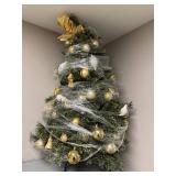 Table Top Decorated Artificial Christmas Tree with Ornaments and Bow Topper - wrapped for storage