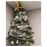 Table Top Decorated Artificial Christmas Tree with Ornaments and Bow Topper - wrapped for storage