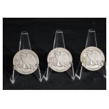 Three Walking Liberty Half Dollars (U.S. 1916-1947) on Display Stands