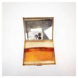 Vintage Gold-Tone Vanity Compact with Mirror, Amber-Toned Base, and Rhinestone Brooch