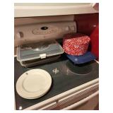 Assorted Kitchen Storage Containers with Plates and Holiday Tin