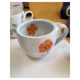 Kitchenware Collection with Coffee Mugs, Glass Bottle, Framed Quote, and Utensils