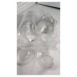 Lot of Various Plastic Containers and Bath Accessories such as clear cups, lids, loofahs, and bath sponges