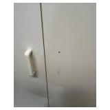 Tall White Storage Cabinet with Assorted Household Supplies