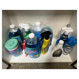 Tall White Storage Cabinet with Assorted Household Supplies