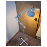Adjustable White Floor Lamp with Articulating Arm and Weighted Base
