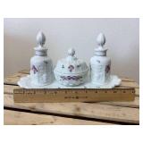 This is a vintage Westmoreland milk glass dresser set in the "Paneled Grape" pattern, hand-painted with a "Roses & Bows" design. The set includes two perfume bottles with stoppers, a covered powder bo