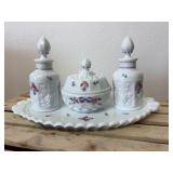 This is a vintage Westmoreland milk glass dresser set in the "Paneled Grape" pattern, hand-painted with a "Roses & Bows" design. The set includes two perfume bottles with stoppers, a covered powder bo