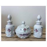 This is a vintage Westmoreland milk glass dresser set in the "Paneled Grape" pattern, hand-painted with a "Roses & Bows" design. The set includes two perfume bottles with stoppers, a covered powder bo