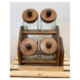 Vintage general store style canister set, The item is a set of four clear glass jars with solid wooden lids and a matching wooden storage rack