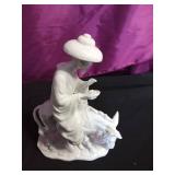 Vintage Blanc de Chine man with bird porcelain figurine and a white porcelain Japanese man riding a donkey figurine